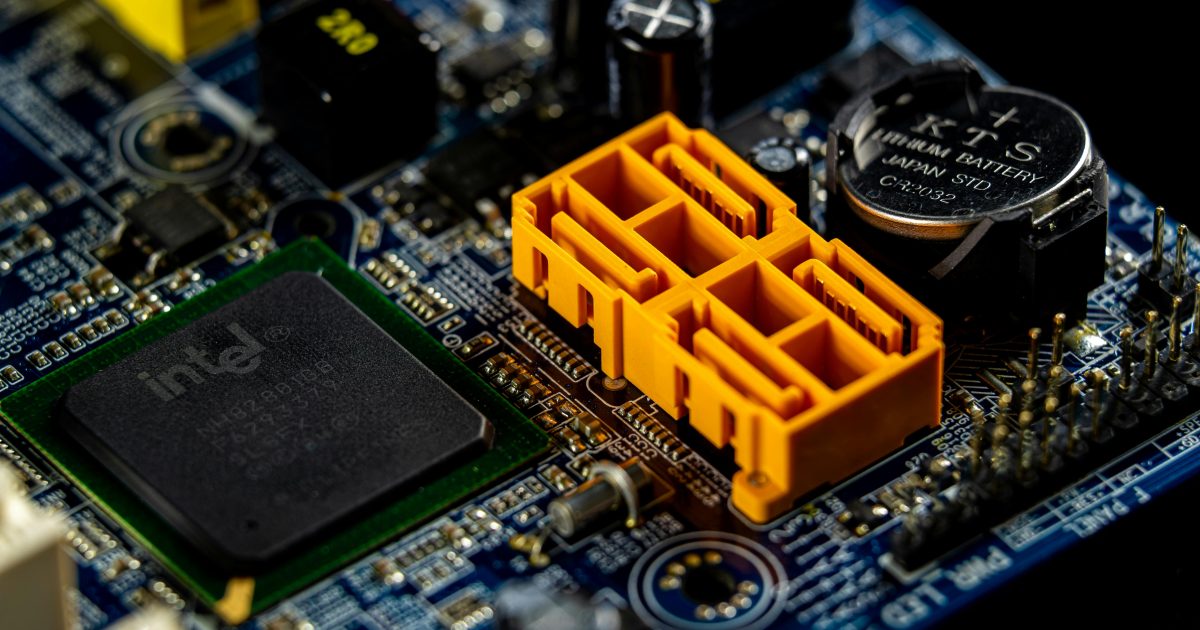 Detailed view of a computer motherboard showcasing an Intel microprocessor and electronic components.