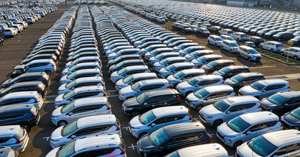 From above of many rows with prestige modern shiny automobiles of manufacture in daytime