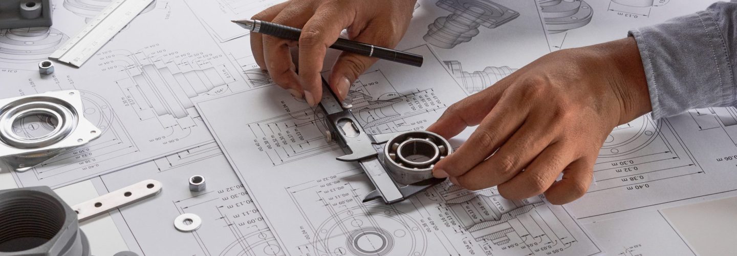Engineer technician designing drawings mechanical parts engineering Engine
manufacturing factory Industry Industrial work project blueprints measuring bearings caliper tools