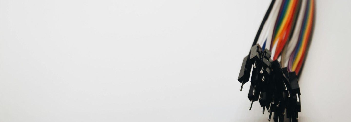Close-up of colorful electronic jumper wires on a white background.