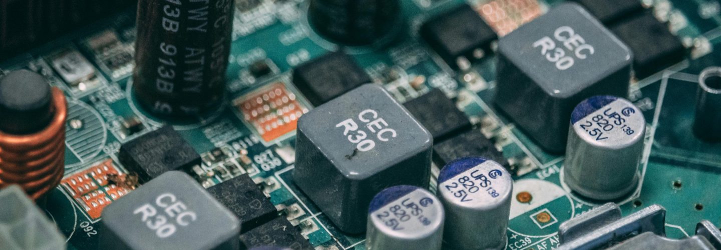 Detailed view of electronic components on a circuit board showcasing capacitors and semiconductors.