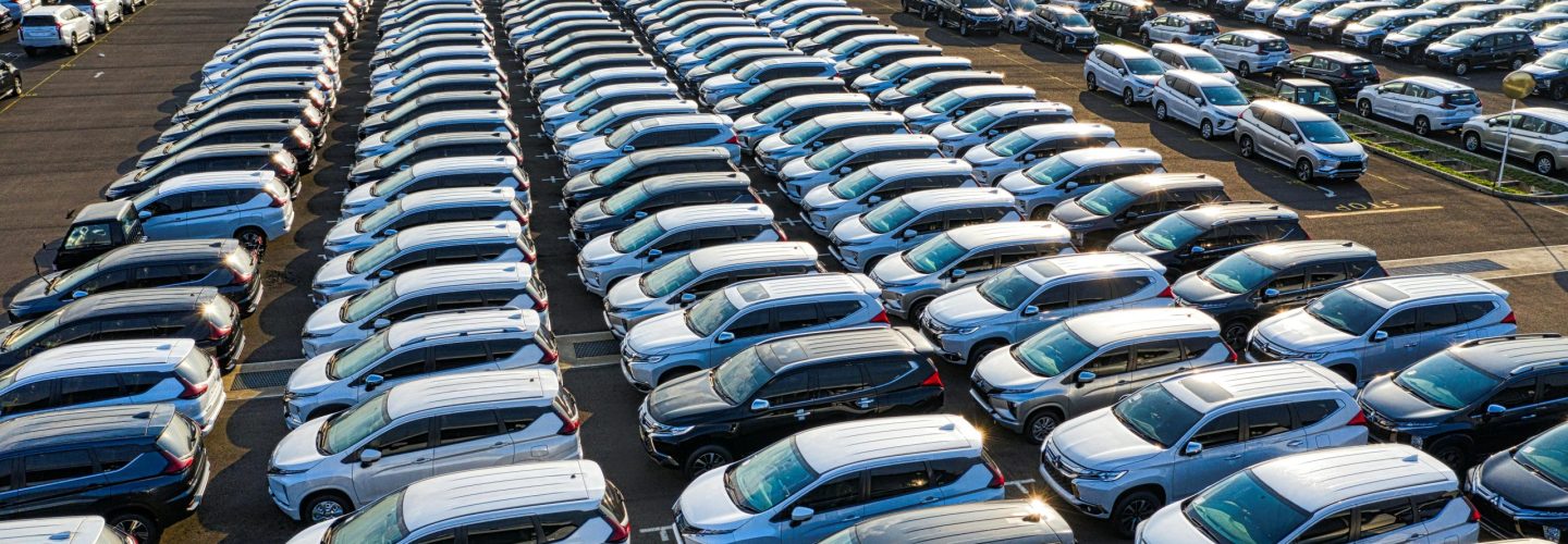 From above of many rows with prestige modern shiny automobiles of manufacture in daytime