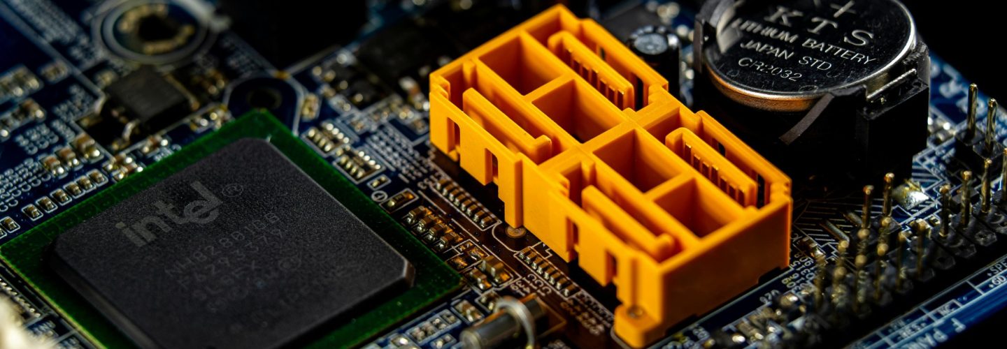 Detailed view of a computer motherboard showcasing an Intel microprocessor and electronic components.